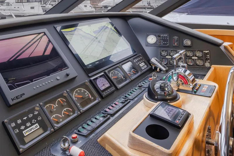 Slide: The Image of 1999 West Bay 58 Pilothouse Motor Yacht helm with navigation screens and controls. - 15