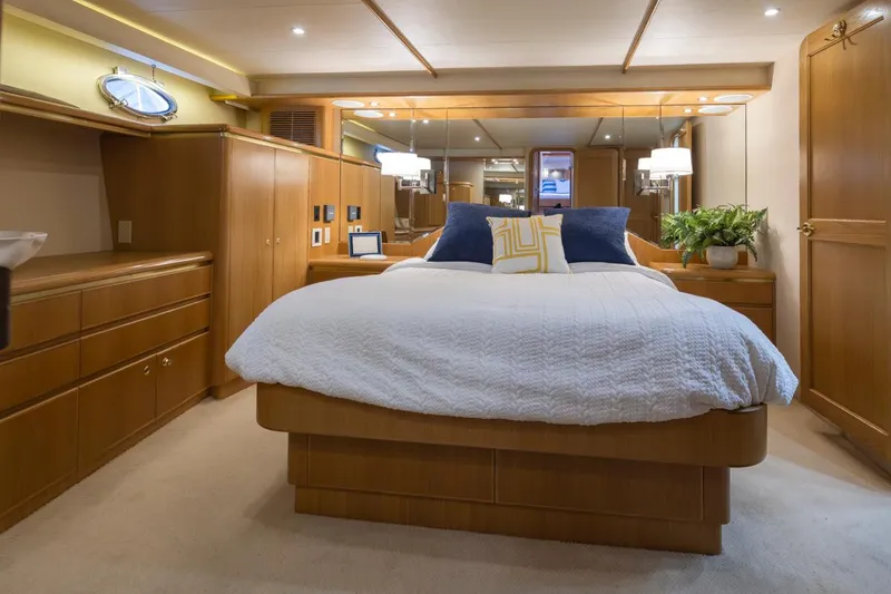 Slide: The Image of Luxurious bedroom in 1999 West Bay 58 Pilothouse Motor Yacht with elegant wood furnishings. - 17
