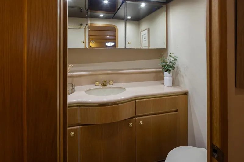Slide: The Image of Luxurious bathroom in 1999 West Bay 58 Pilothouse Motor Yacht with elegant wood cabinetry. - 20