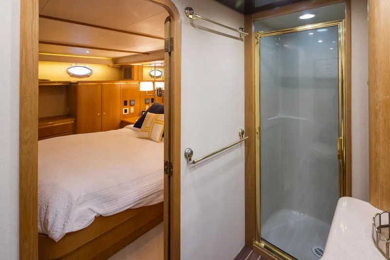 Slide: The Image of Luxurious bedroom and bathroom in 1999 West Bay 58 Pilothouse Motor Yacht. - 22
