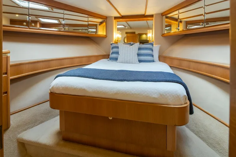 Slide: The Image of Luxurious bedroom in 1999 West Bay 58 Pilothouse Motor Yacht with elegant wood finishes. - 24
