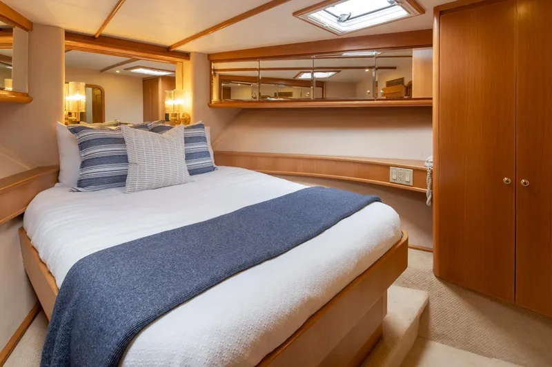 Slide: The Image of Luxurious bedroom in 1999 West Bay 58 Pilothouse Motor Yacht with cozy bedding and wood accents. - 25