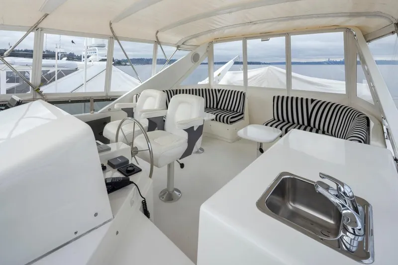 Slide: The Image of Luxurious 1999 West Bay 58 Pilothouse Motor Yacht interior with seating and sink. - 30