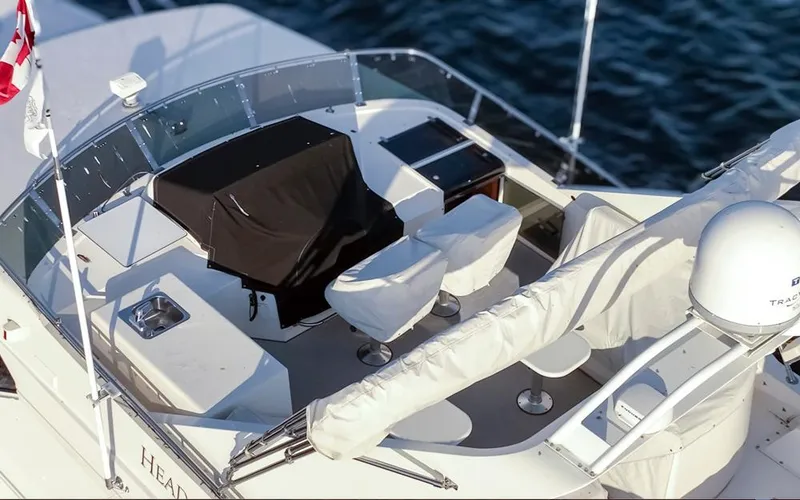 Slide: The Image of 1999 West Bay 58 Pilothouse Motor Yacht deck with seating and navigation equipment. - 33