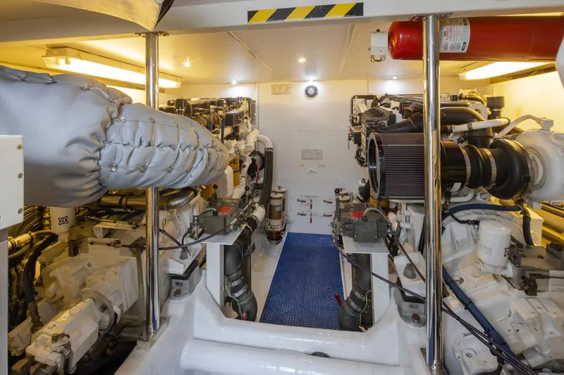 Slide: The Image of Engine room of 1999 West Bay 58 Pilothouse Motor Yacht, featuring dual engines and equipment. - 34