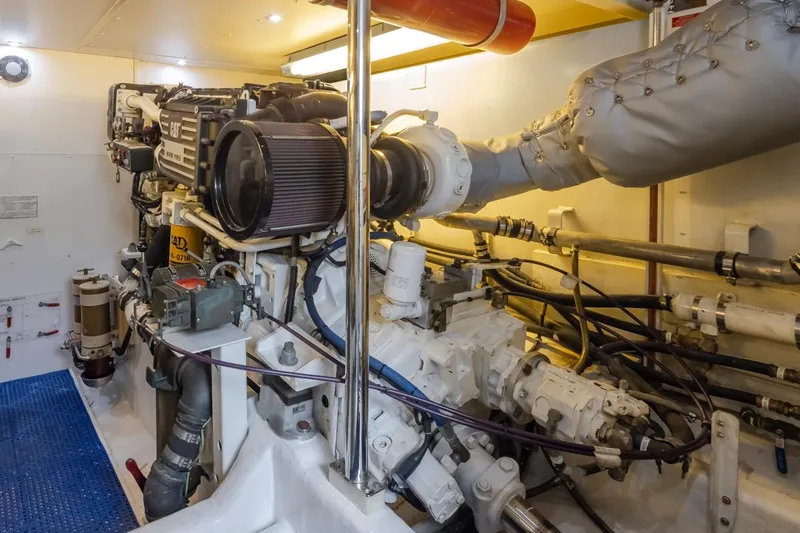 Slide: The Image of Engine room of 1999 West Bay 58 Pilothouse Motor Yacht, showcasing mechanical components and piping. - 36
