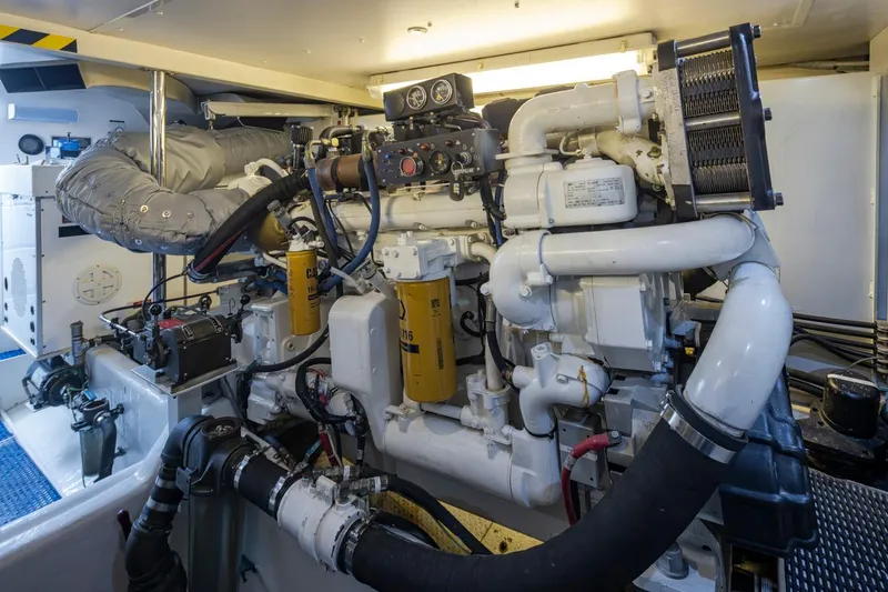 Slide: The Image of Engine room of 1999 West Bay 58 Pilothouse Motor Yacht, showcasing complex machinery and components. - 40
