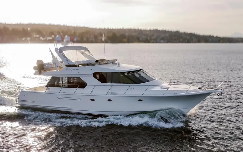 Slide: The Image of 1999 West Bay 58 Pilothouse Motor Yacht cruising on open water. - 45