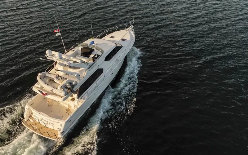 Slide: The Image of Aerial view of 1999 West Bay 58 Pilothouse Motor Yacht cruising on open water. - 47