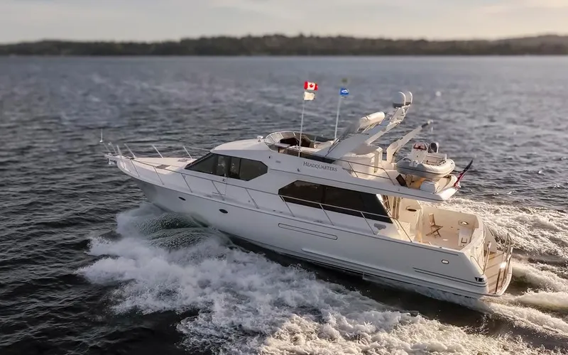 Slide: The Image of 1999 West Bay 58 Pilothouse Motor Yacht cruising on open water. - 48