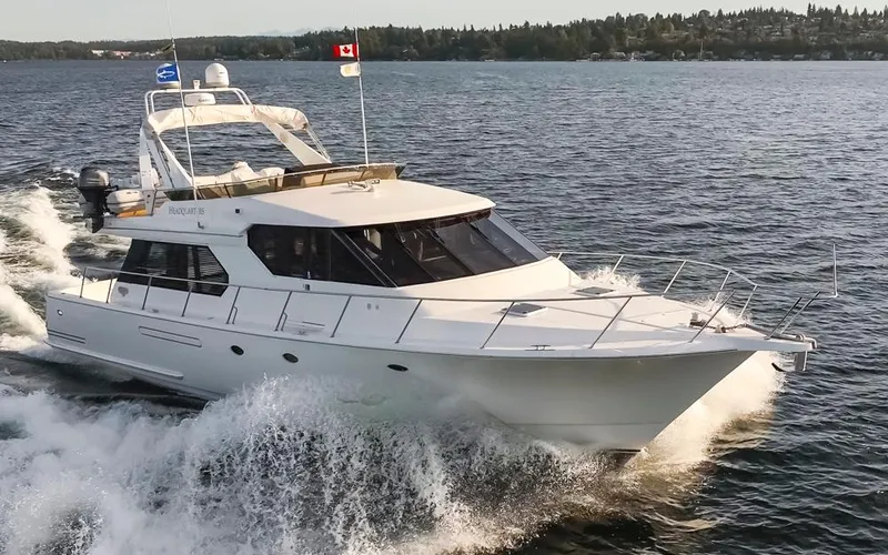 Slide: The Image of 1999 West Bay 58 Pilothouse Motor Yacht cruising on open water. - 49