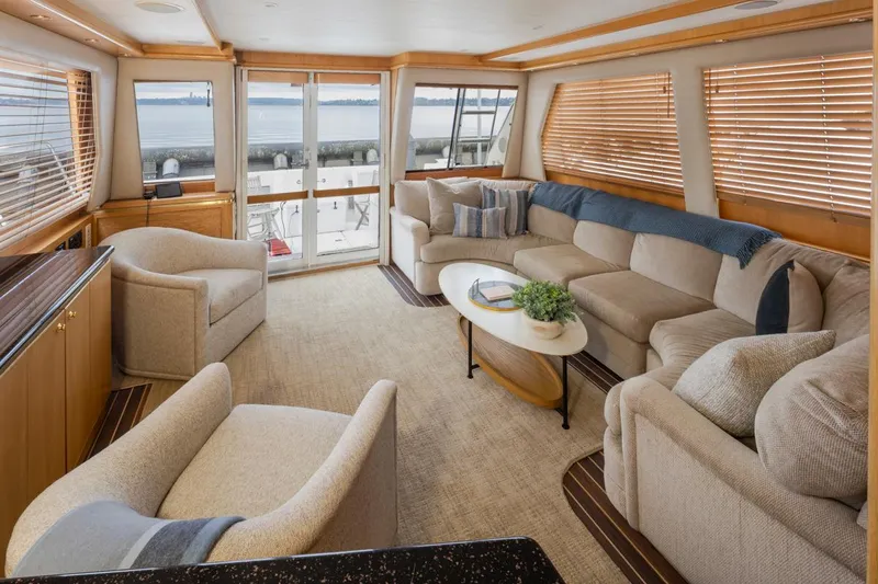 Slide: The Image of Luxurious interior of 1999 West Bay 58 Pilothouse Motor Yacht with plush seating and panoramic windows. - 5