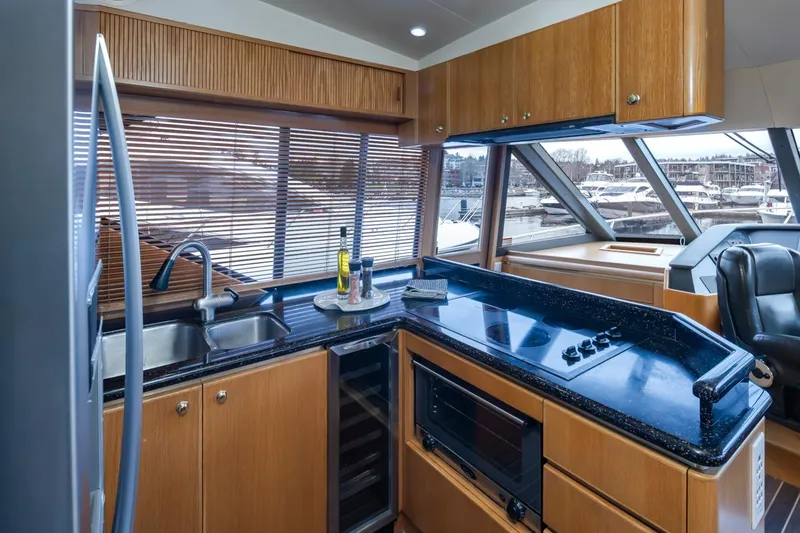 Slide: The Image of Luxurious kitchen interior of 1999 West Bay 58 Pilothouse Motor Yacht with modern amenities. - 8