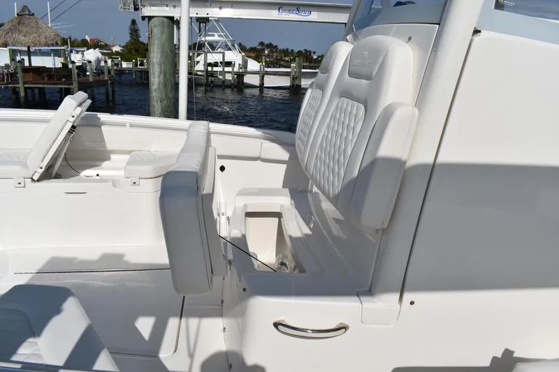Slide: The Image of 2024 Regulator 26XO boat interior with white seating and storage compartment. - 10