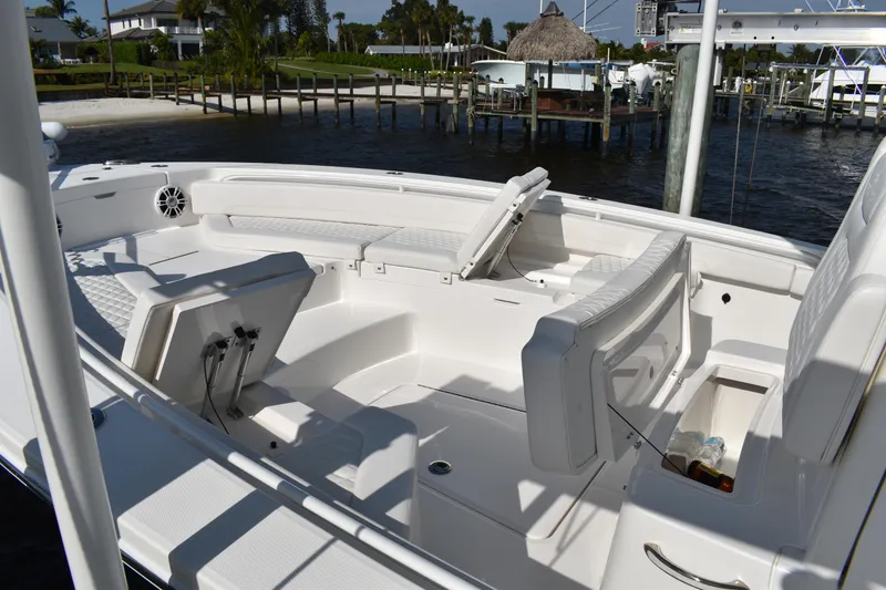 Slide: The Image of 2024 Regulator 26XO boat interior with white seating and waterfront view. - 11