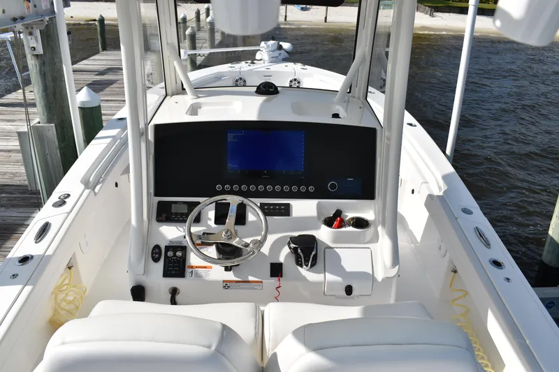 Slide: The Image of 2024 Regulator 26XO boat cockpit with modern steering and navigation system. - 13