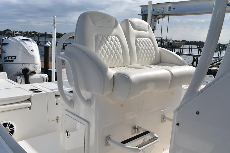 Slide: The Image of 2024 Regulator 26XO boat with white cushioned seating and Yamaha XTO outboard motor. - 15