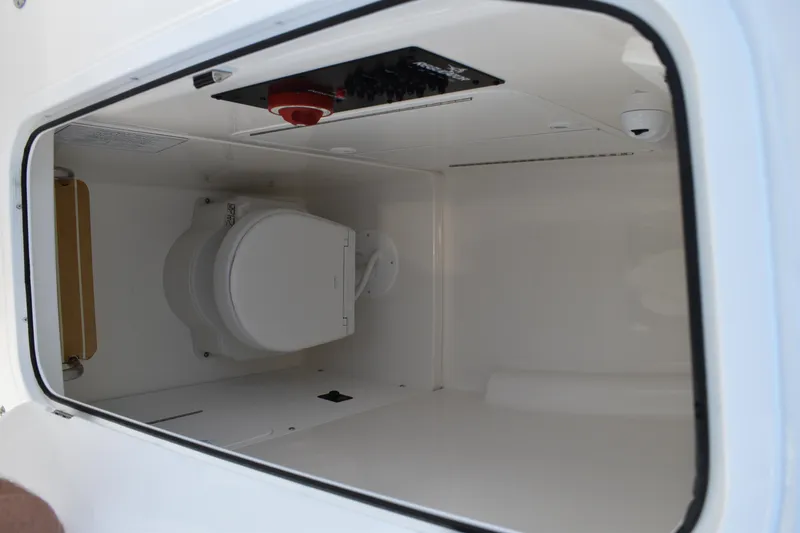 Slide: The Image of 2024 Regulator 26XO boat interior with compact marine toilet. - 18