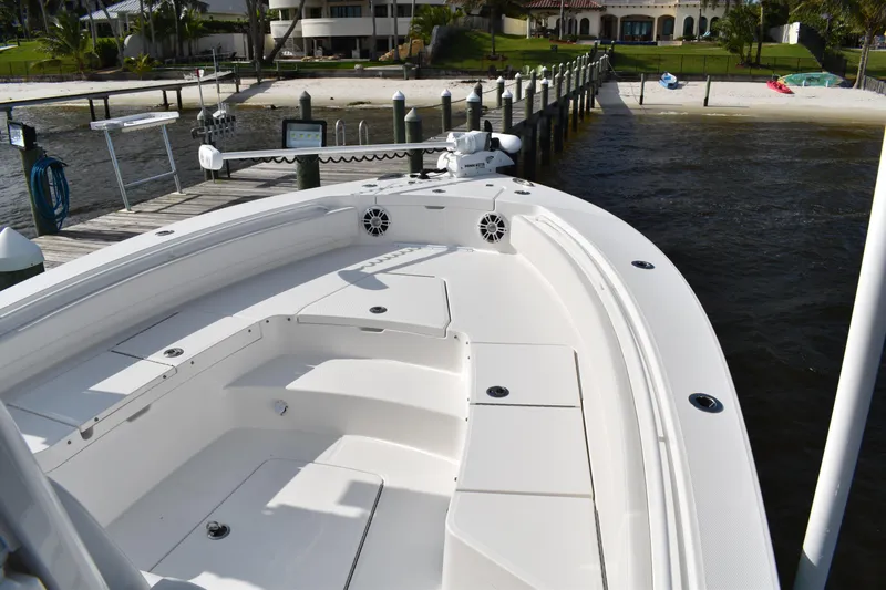 Slide: The Image of 2024 Regulator 26XO boat docked by waterfront with spacious deck and seating. - 22