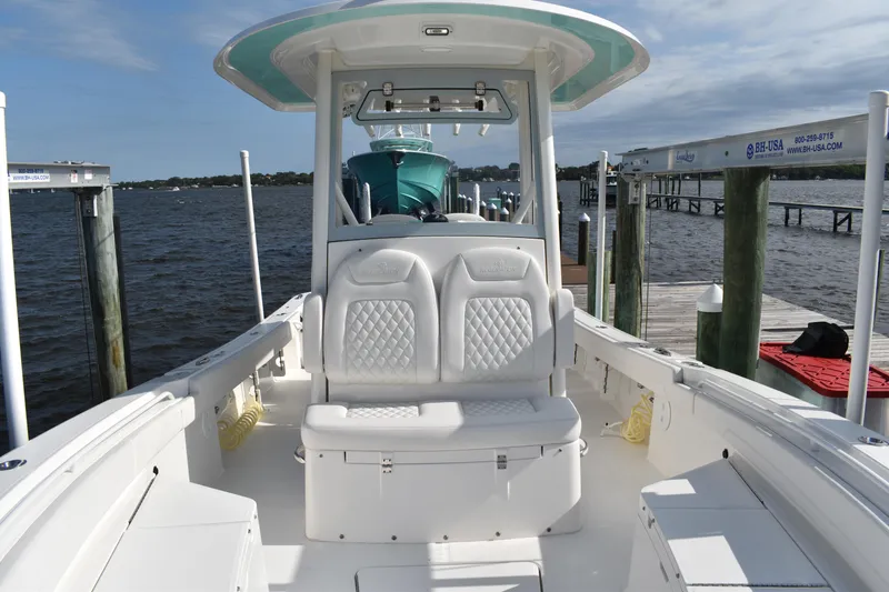 Slide: The Image of 2024 Regulator 26XO boat interior at dock, featuring seating and console. - 23
