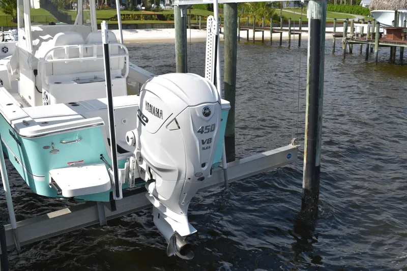 Slide: The Image of 2024 Regulator 26XO boat with Yamaha 450 V8 engine on a lift. - 26