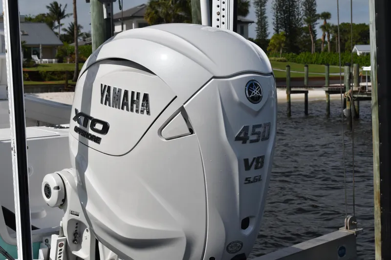 Slide: The Image of 2024 Regulator 26XO with Yamaha 450 V8 outboard engine by the water. - 27