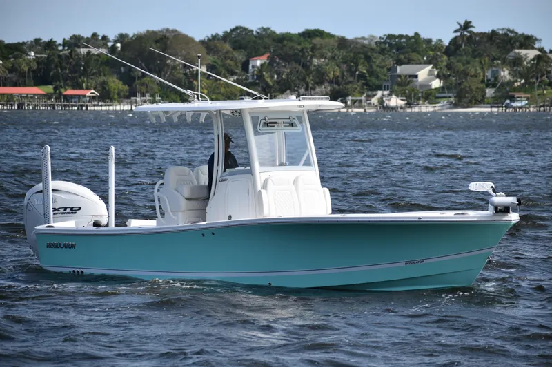 Slide: The Image of 2024 Regulator 26XO boat on water, featuring sleek design and modern amenities. - 3