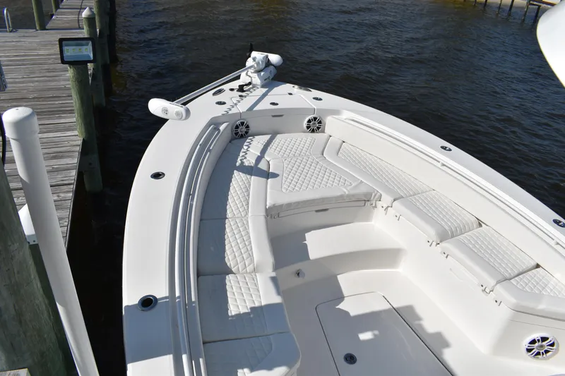Slide: The Image of 2024 Regulator 26XO boat with spacious seating and sleek design at a dock. - 7