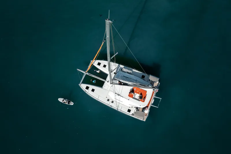 Slide: The Image of Aerial view of 2025 Excess 14 catamaran sailing on clear blue water. - 7