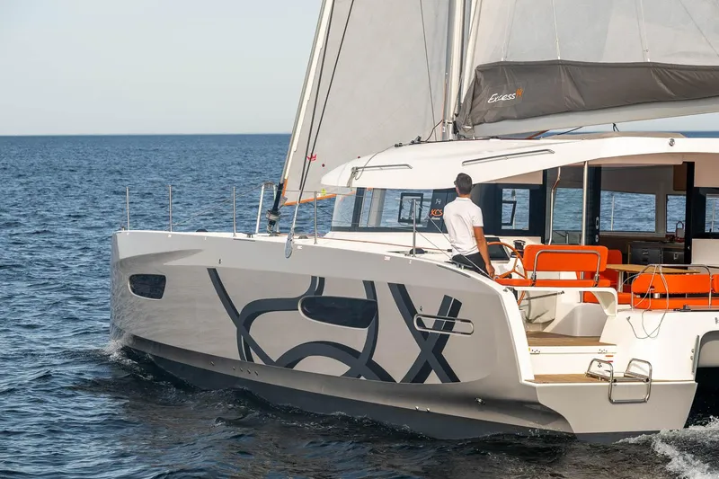 Slide: The Image of Sailing yacht Excess 14, 2025 model, cruising on open sea with vibrant orange seating. - 2