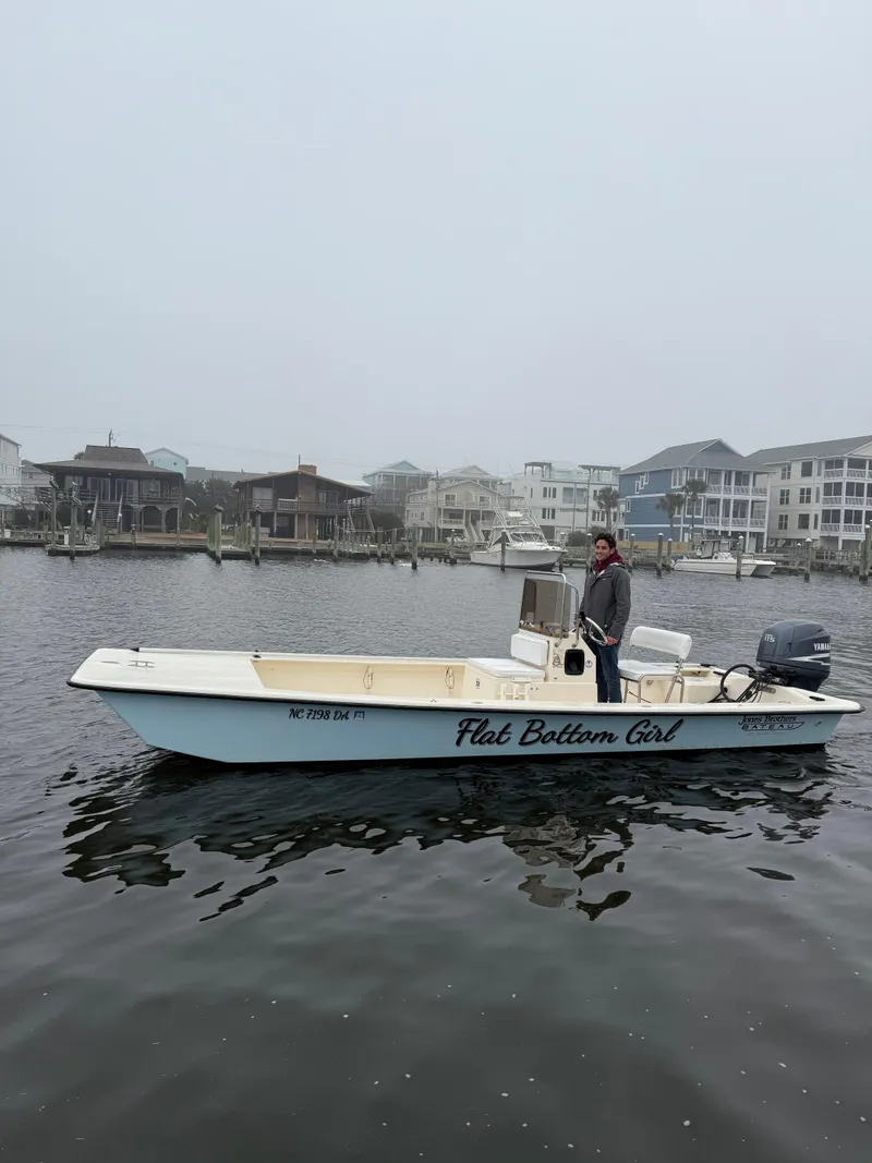 Slide: The Image of 2005 Jones Brothers 22 Bateau boat on water, overcast day, coastal houses in background. - 1