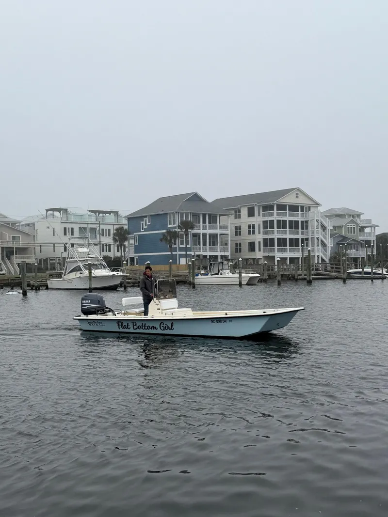 Slide: The Image of 2005 Jones Brothers 22 Bateau boat cruising near waterfront homes on a foggy day. - 4