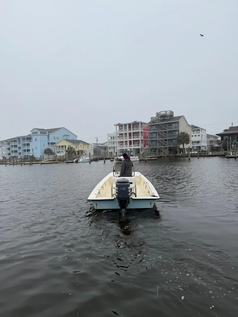 Slide: The Image of 2005 Jones Brothers 22 Bateau boat on water near coastal buildings. - 5