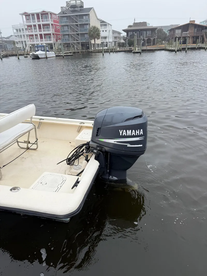 Slide: The Image of 2005 Jones Brothers 22 Bateau boat with Yamaha outboard motor on a calm waterfront. - 6