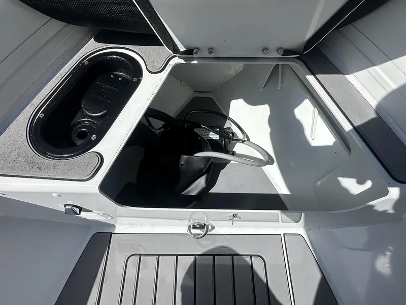 Slide: The Image of 2022 Highfield Sport 420 boat storage compartment with open hatch and visible interior details. - 13