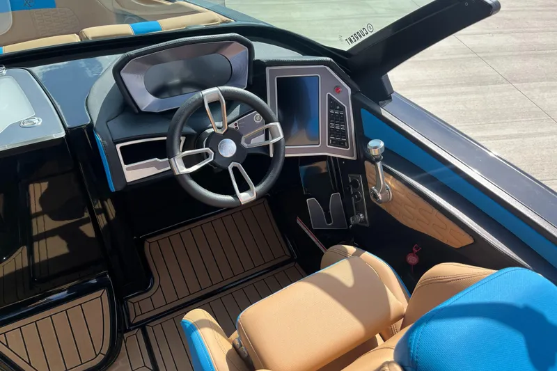 Slide: The Image of 2022 MasterCraft X26 boat interior with modern steering and dashboard controls. - 11