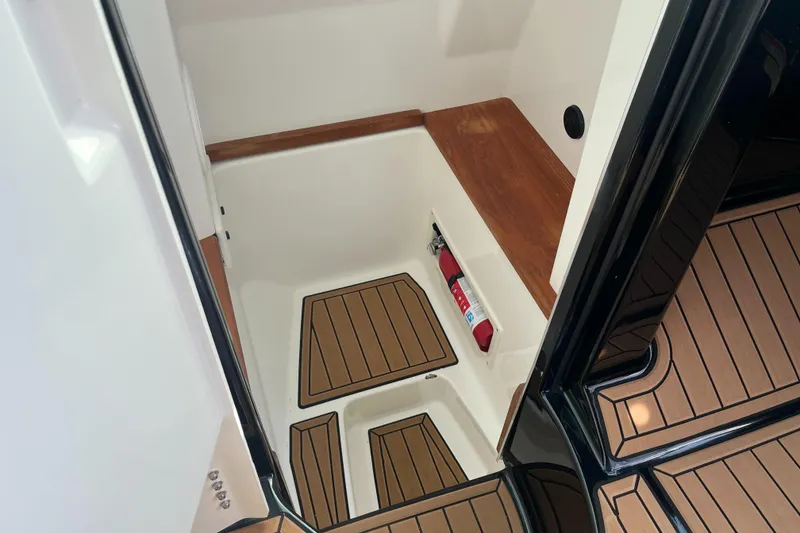 Slide: The Image of 2022 MasterCraft X26 interior with teak flooring and storage compartment. - 15