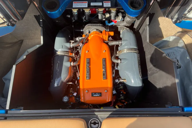 Slide: The Image of 2022 MasterCraft X26 engine compartment with vibrant orange engine cover. - 16