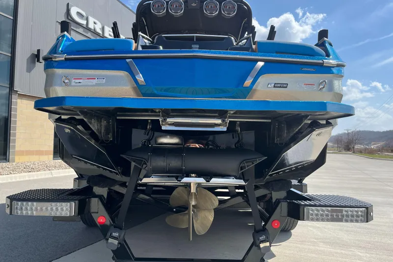 Slide: The Image of 2022 MasterCraft X26 boat, rear view, showcasing propeller and sleek blue design. - 8
