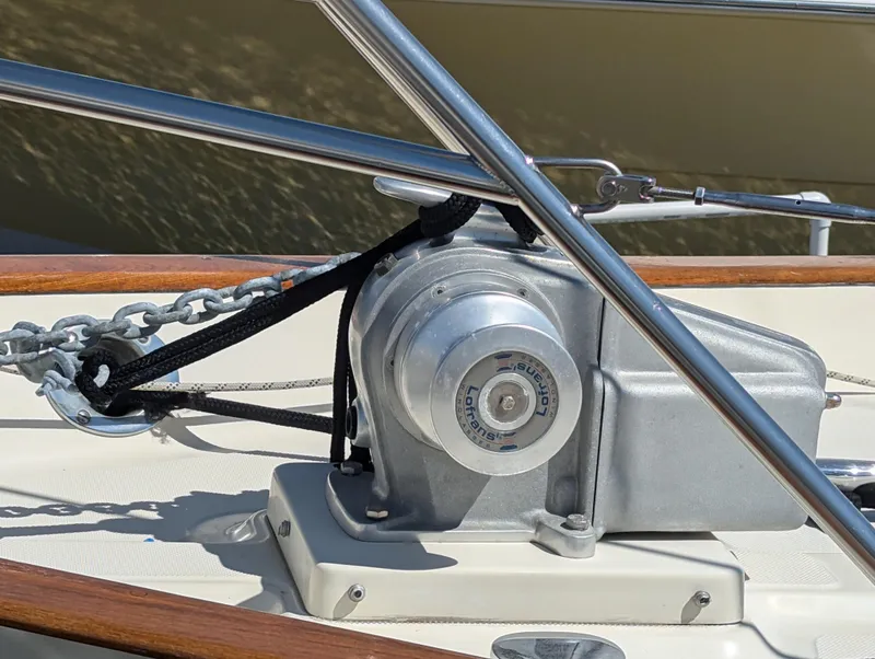 Slide: The Image of Windlass on 1995 Pacific Seacraft 34 sailboat deck, featuring chain and metal fittings. - 32