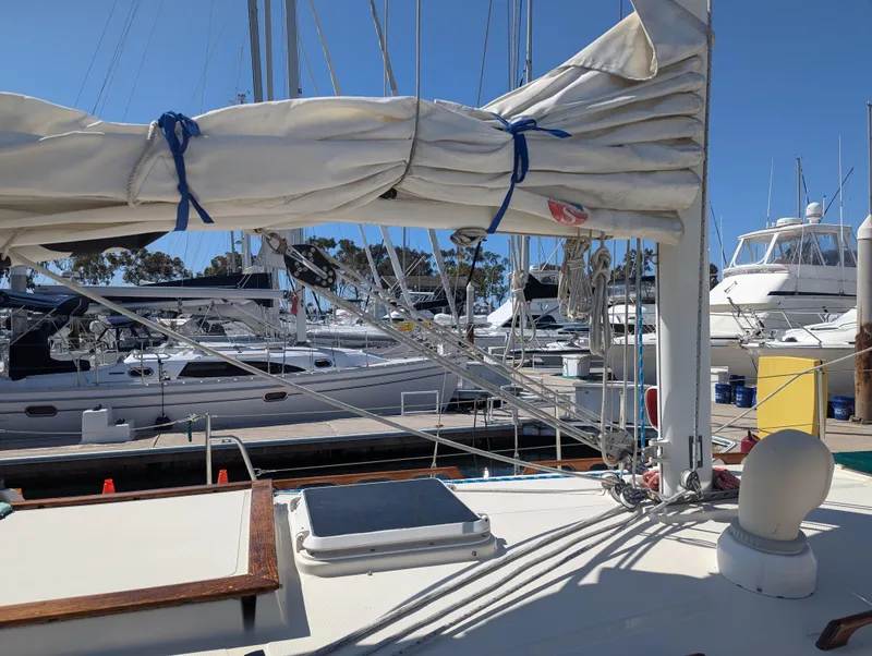 Slide: The Image of Sailboat docked at marina, Pacific Seacraft 34, 1995 model, with wrapped sails. - 36