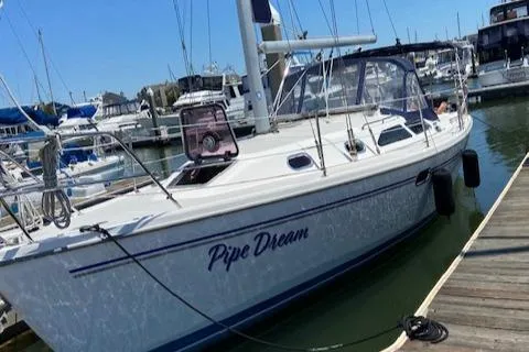Slide: The Image of 2005 Catalina 310 sailboat named "Pipe Dream" docked at a marina. - 0