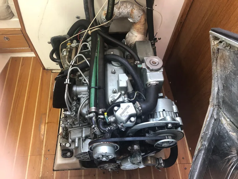 Slide: The Image of 2005 Catalina 310 engine, detailed view, installed on wooden flooring. - 11