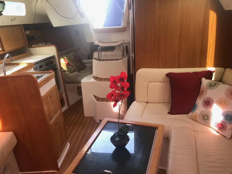 Slide: The Image of Interior of a 2005 Catalina 310 sailboat with cozy seating and wooden finishes. - 12