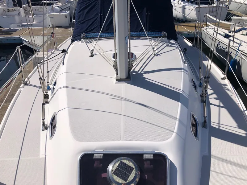 Slide: The Image of 2005 Catalina 310 sailboat deck view at marina, showcasing mast and rigging. - 15