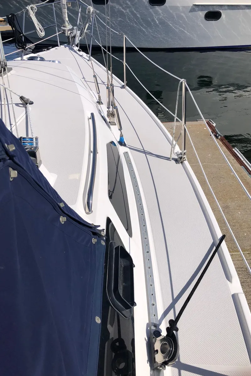 Slide: The Image of 2005 Catalina 310 sailboat deck view at marina, showcasing rigging and sleek design. - 17