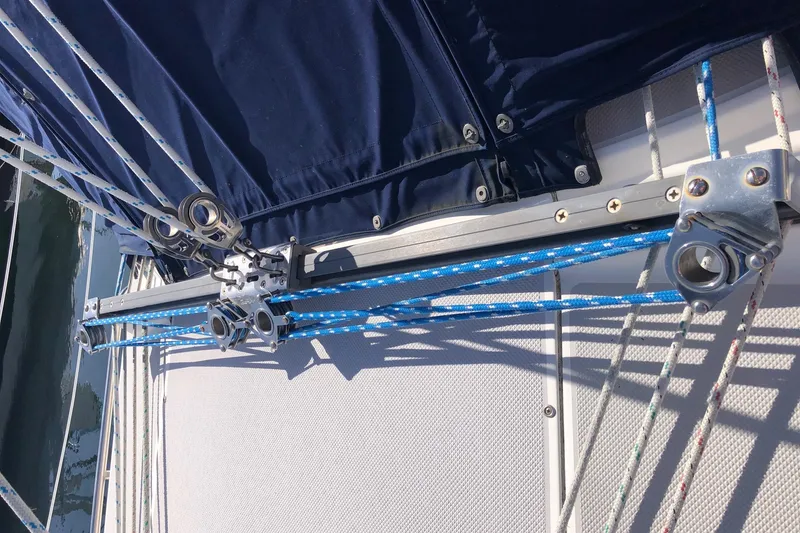 Slide: The Image of Sailing rigging on a 2005 Catalina 310 boat with blue ropes and metal fittings. - 18