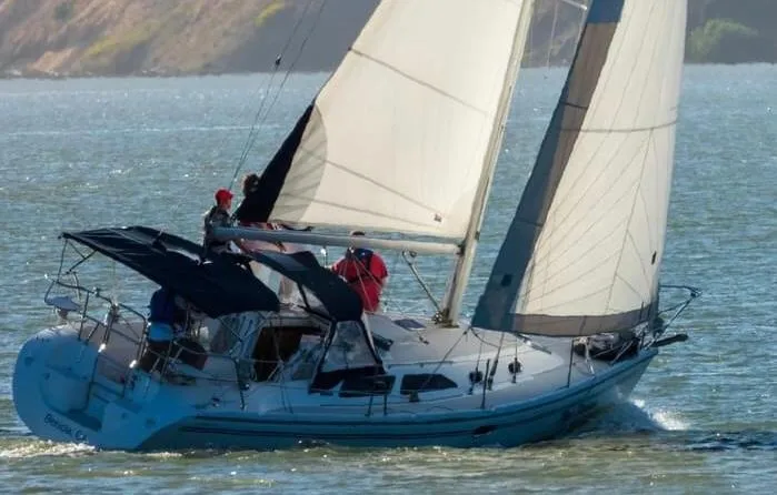 Slide: The Image of Sailboat Catalina 310, 2005 model, navigating on a sunny day. - 25