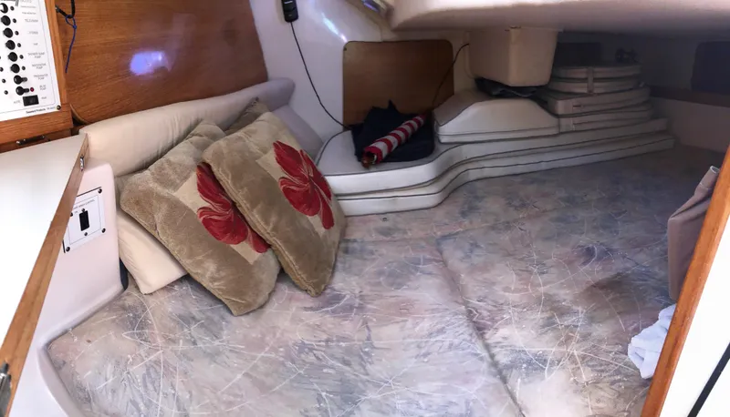 Slide: The Image of Cozy interior cabin of a 2005 Catalina 310 sailboat with cushions and pillows. - 9