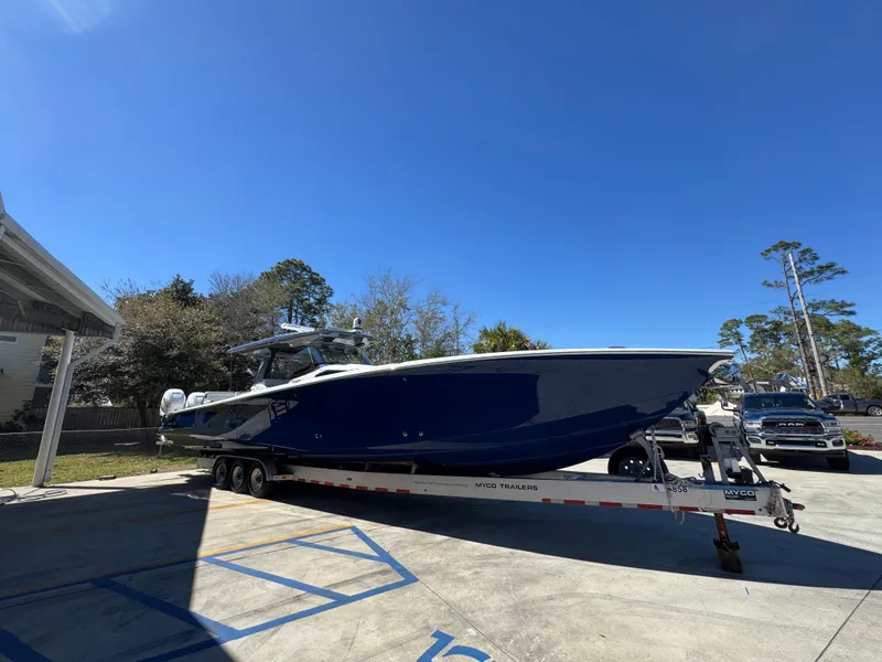 Slide: The Image of 2018 Nor-Tech 452 Super Fish boat on trailer, parked outdoors under clear blue sky. - 10